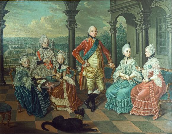 Ludwig Friedrich Carl Fürst zu Hohenlohe-Neuenstein-Öhringen (23.5.1723 - 27.7.1805) und seine Familie auf der Terrasse von Schloss Weikersheim mit dem Schlossgarten und der Orangerie im Hintergrund. Deutlich sichtbar: die Zypressen.